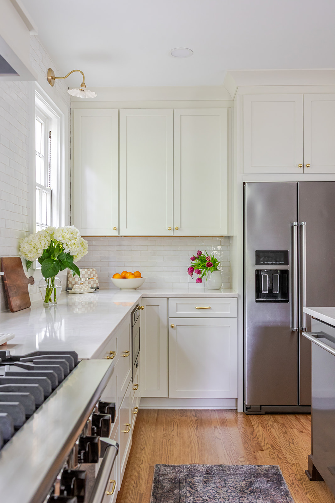 Scherr kitchen remodel with white cabinetry and brass hardware