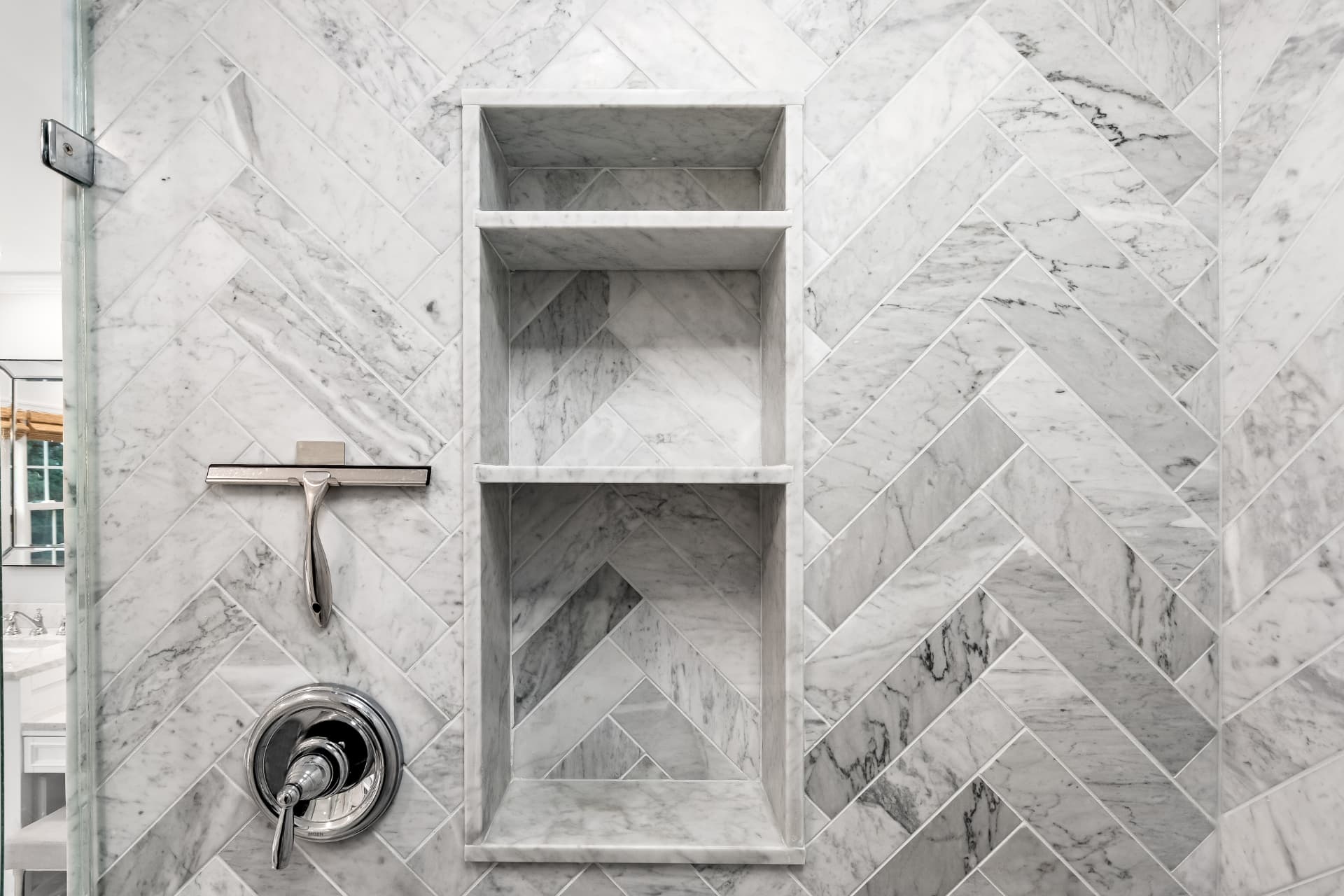Scherr bathroom remodel with marble herringbone shower tile and recessed niche