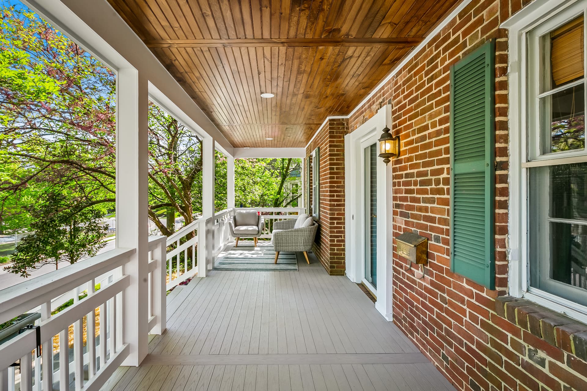 Scherr covered porch renovation with wood ceiling and brick exterior