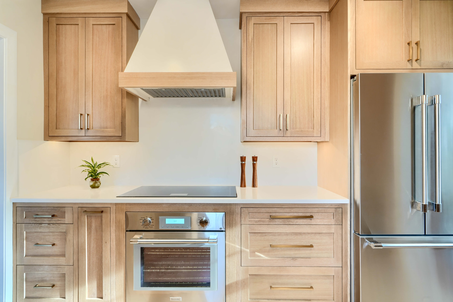 Scherr kitchen remodel with white oak cabinetry, range hood, and stainless appliances